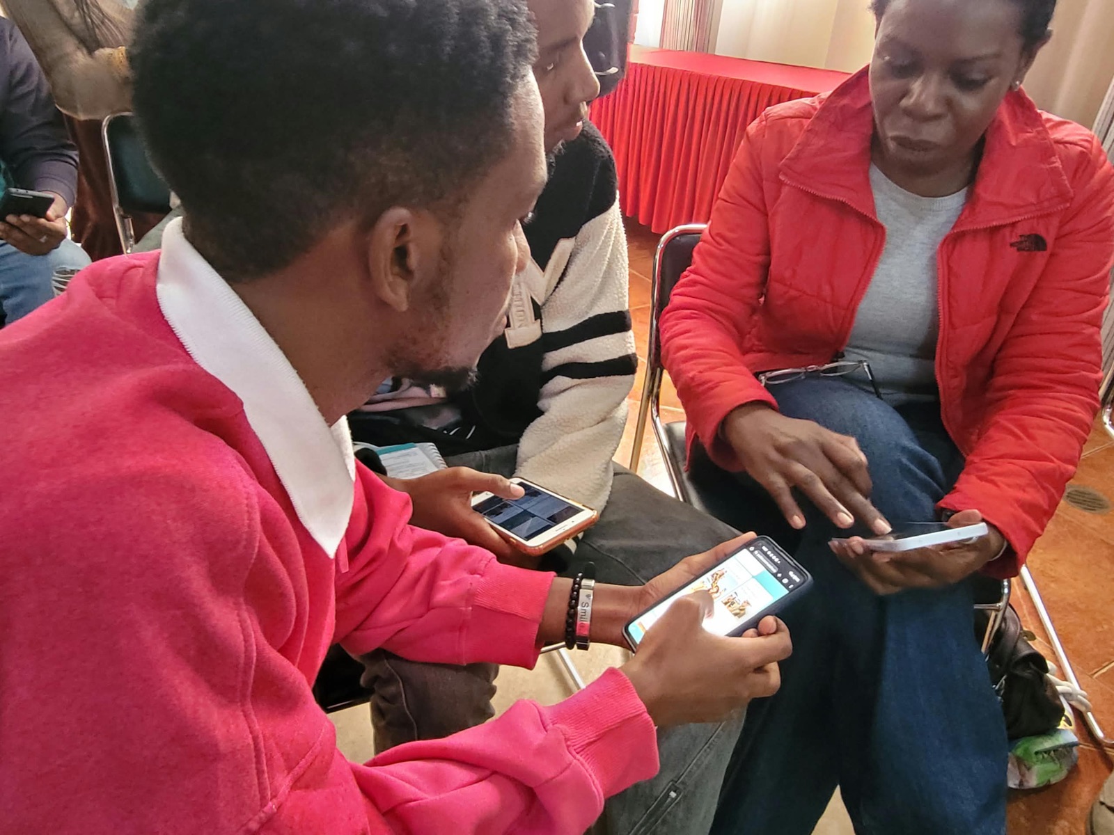 Participants work through an AI exercise together on their phones